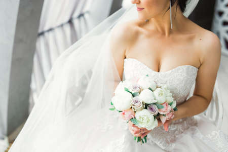 Portrait of stunning bride with long hair posing with great bouquetの写真素材