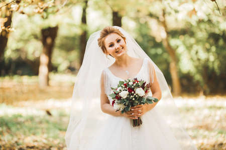 Luxury wedding bride, girl posing and smiling with bouquetの写真素材