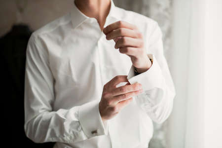 Beautiful man, groom posing and preparing for wedding