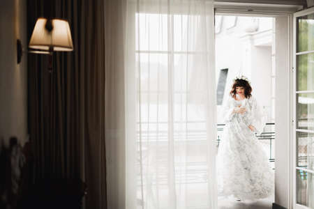 Luxury bride in white dress posing while preparing for the wedding ceremonyの写真素材