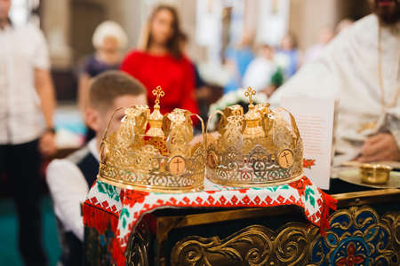 Golden crowns lying on the table in churchの写真素材