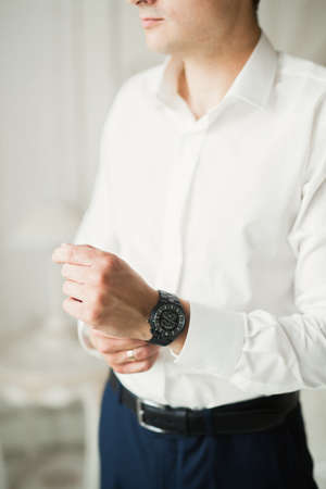 Beautiful man, groom posing and preparing for weddingの写真素材