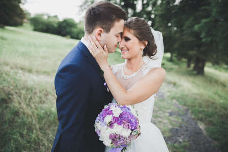 Kissing wedding couple in spring nature close-up portraitの写真素材