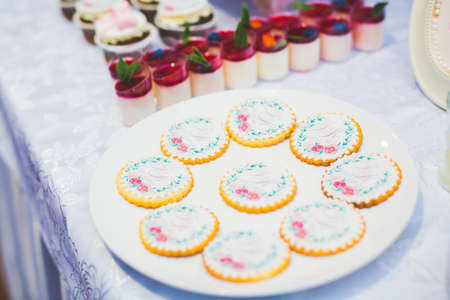 Delicious sweets on wedding candy buffet with desserts, cupcakes