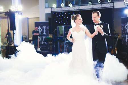 First wedding dance of newlywed couple in restaurantの写真素材