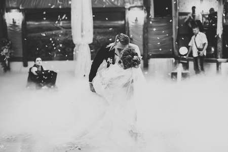 Beautiful caucasian wedding couple just married and dancing their first danceの写真素材