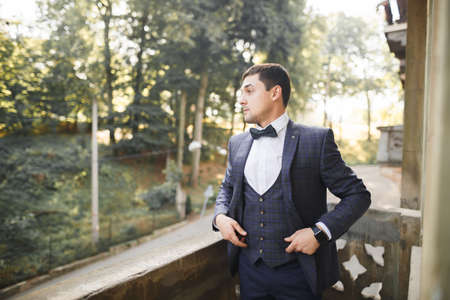 Young handsome man relaxing at his apartment in a hotel after business meetingの写真素材