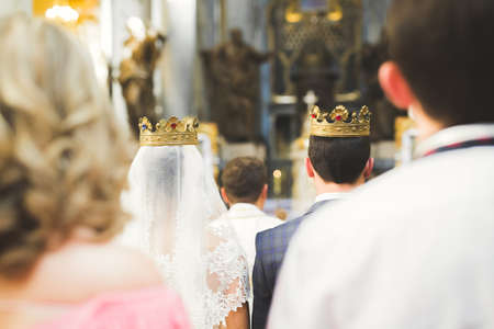 Married couple posing in a church after ceremony