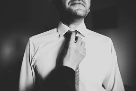 Young handsome man relaxing at his apartment in a hotel after business meetingの写真素材