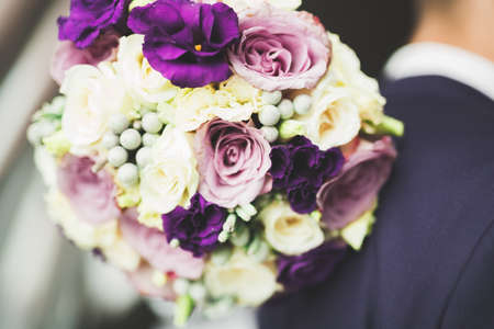 Bride holding big and beautiful wedding bouquet with flowersの写真素材