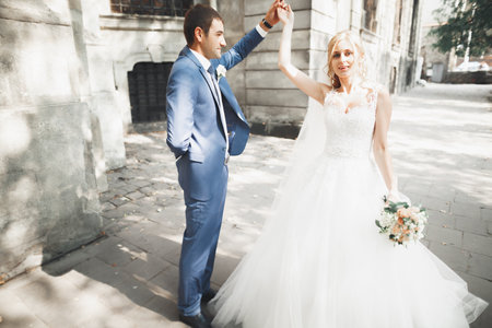 Gorgeous wedding couple walking in the old city of Lvivの写真素材