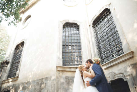 Gorgeous wedding couple walking in the old city of Lvivの写真素材