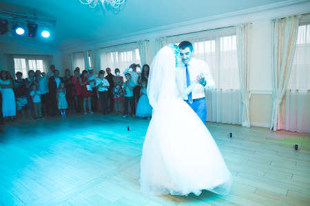 Beautiful caucasian wedding couple just married and dancing their first danceの写真素材