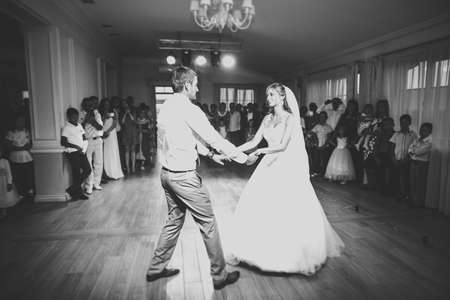 Beautiful caucasian wedding couple just married and dancing their first danceの写真素材