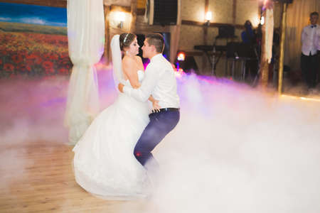 Beautiful caucasian wedding couple just married and dancing their first danceの写真素材