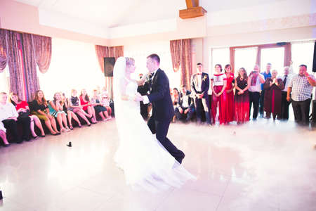 Beautiful caucasian wedding couple just married and dancing their first danceの写真素材
