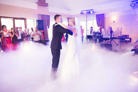 First wedding dance of newlywed couple in restaurantの写真素材