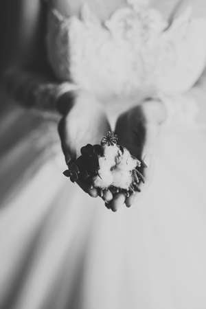 Beautiful bride wearing fashion wedding dress with feathers with luxury delight make-up and hairstyle, studio indoor photo shootの写真素材