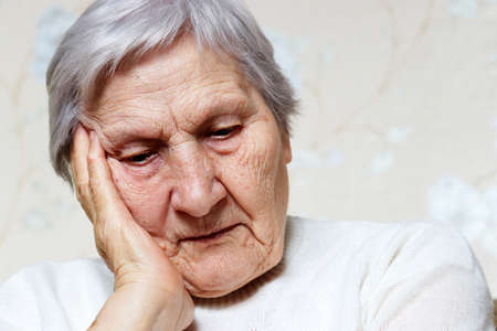 Portrait of elderly woman thinking about something. Concept of retired, brain activity in old age, memories of the pastの写真素材