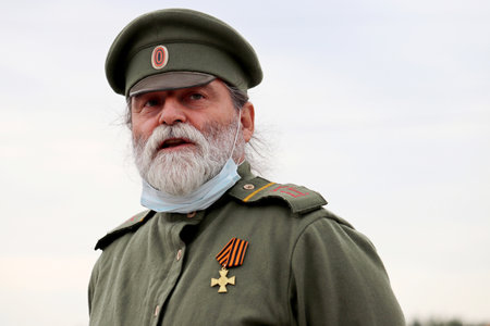 Moscow, Russia - September 2020: Bearded soldier of the Russian Empire of early 20th century with mask during the historical reconstruction of the World war Iのeditorial素材