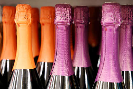 Champagne bottles in a row, selective focus. Liquor store, sparkling wine production conceptの写真素材