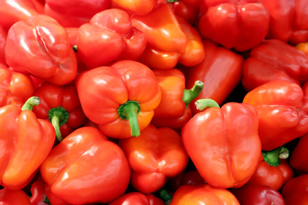 Sweet pepper close up. Red bell peppers on a market, paprika, vegetable background