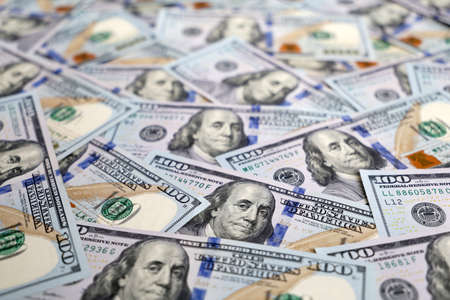 A lot of one hundred US dollars bills, paper currency for background. Concept of american and global...
