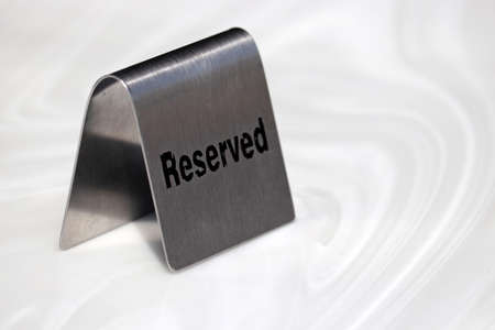 Metal sign with the inscription Reserved on a cafe tableの写真素材