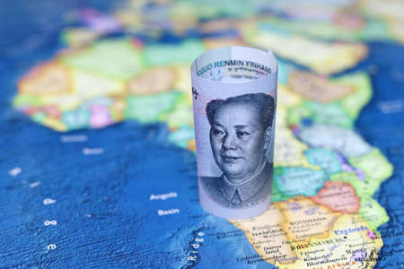 Chinese yuan on the map of Africa continent. Trading between China and African countries, tourism, economy and investmentの写真素材