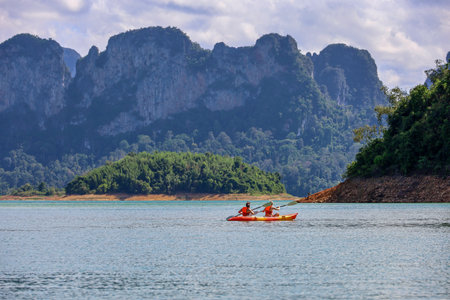 Tourists riding kayak on Cheo Lan lake at Surat Thani province of Thailand. Picturesque landscape of national Khao Sok parkの写真素材