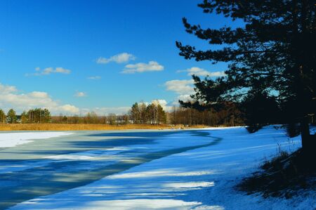 Bright Sunny frosty day. A cleared skating rink on the surface of a frozen river.の写真素材