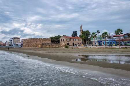 Lively finikoudes beach next to the old castle in the city center. Larnaca, Cyprus-March 2019