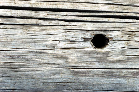 Cracked wood texture Board in natural gray color with a round hole. Back backgroundの写真素材