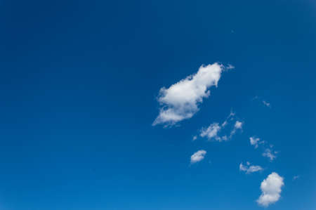 Bright blue sky with white clouds scattered on a natural background