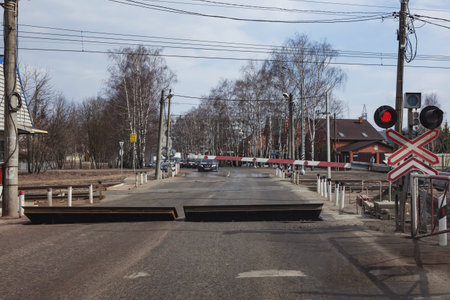 There are cars at the railway crossing. The barrier is lowered the red signal of the semaphore is...