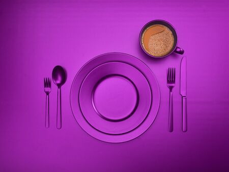 Cup of coffee with blue plates, fork, knife and spoon, top view. Ceramic dishes with a set of cutlery. Empty blue dishes for breakfast or dinner in a restaurant. Copyspace for your individual text.の写真素材