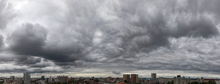 Panoramic view of the city under the dark storm clouds.の写真素材