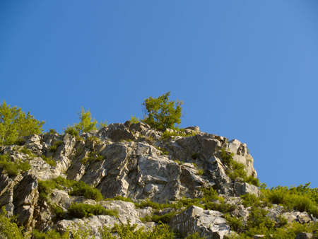 Stone declivity of mountain under blue sky の写真素材