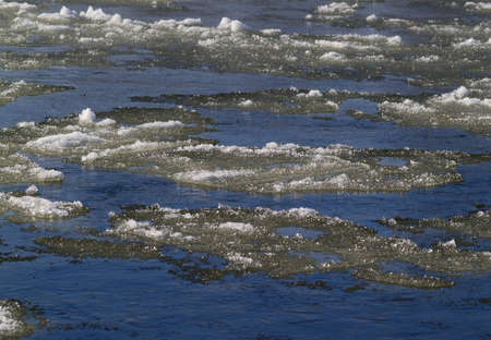 Ice floating on small river in the beginning of winter