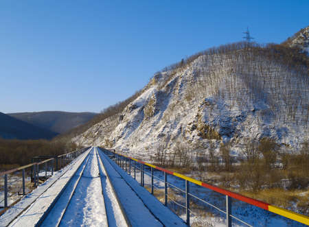 Winter landscape with the railway bridge at a mountain slope  の写真素材
