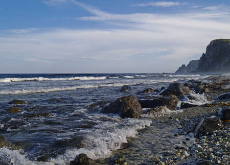 Sea landscape with rocky coast in cloudy weatherの写真素材