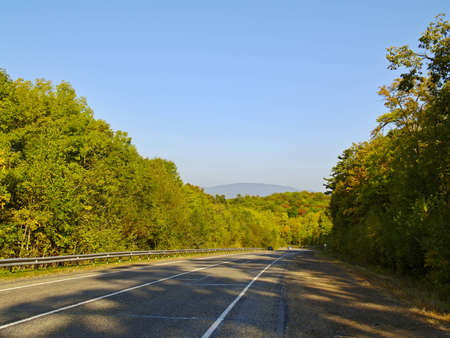 Road from pass in the solar autumn afternoon