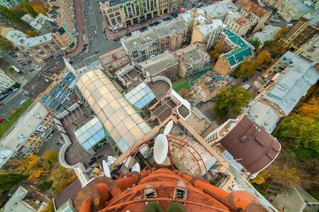 Cityscape from the rooftop, the photographer's feet in the frame.のeditorial素材