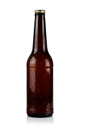 brown chilled bottle of beer on a white background.の写真素材