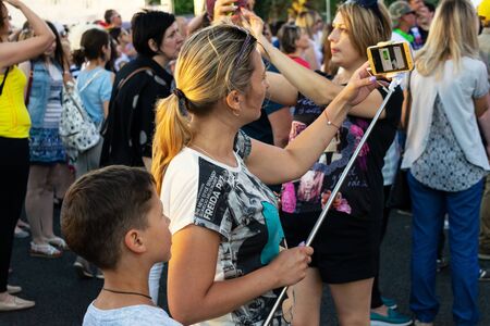 Samara, Russia, 28 June 2018.Fans hurriedly until the sun goes down make selfies