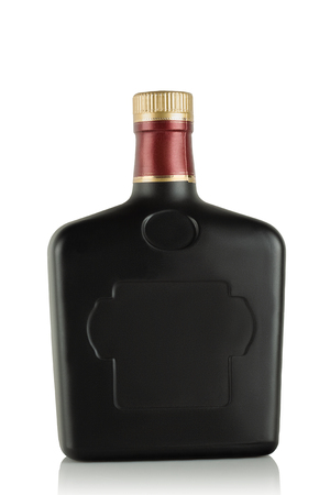 Black frosted-glass bottle with an alcoholic beverageの写真素材