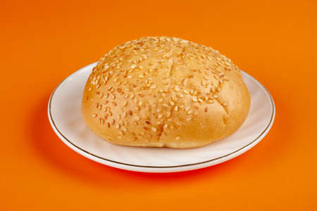 Fresh, delicious sesame bun on a white plateの写真素材