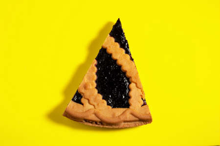 A piece of sweet and delicious blueberry pie on a yellow backgroundの写真素材