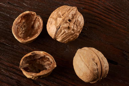 Ripe walnuts on a brown wooden surface