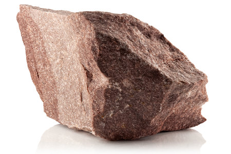 A stone, a rough fragment of crimson quarter on a white backgroundの写真素材